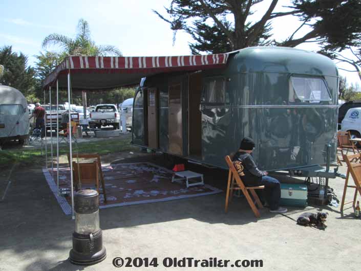 Beautifully restored vintage 1948 Vagabond trailer with a striped canvas awning