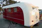 Photo shows the rear end of a beautifully restored 1949 Vagabond trailer