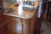 Beautifully restored galley cabinet workwork and stone countertop in 1950 Airfloat LandYacht vintage trailer
