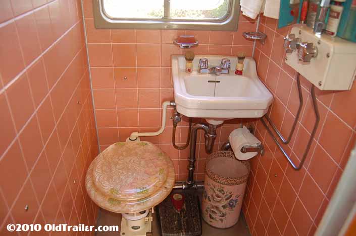 Photo shows a 1951 Vagabond trailer with a vintage toilet and bathroom