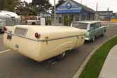 Picture of a vintage studebaker lark wagon towing a 1954 ranger pop-up trailer