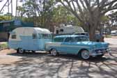 Photo of a 1956 chevy nomad wagon towing a vintage shasta trailer