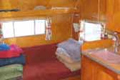Photo of warm bedroom plywood paneling in 1960 Shasta Airflyte trailer