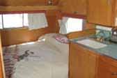 1961 Shasta vintage trailer with cozy bedroom and retro cowboy styled bedspread