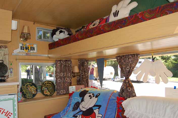 Photo shows fun Mickey Mouse decorations in the bedroom area of an Aladdin Vintage Travel Trailer