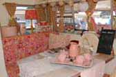 Stylish pink and white decorations in dining area of 1969 Shasta Starflyte Travel Trailer