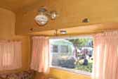 Picture shows very original dining area in a vintage Aloha travel trailer