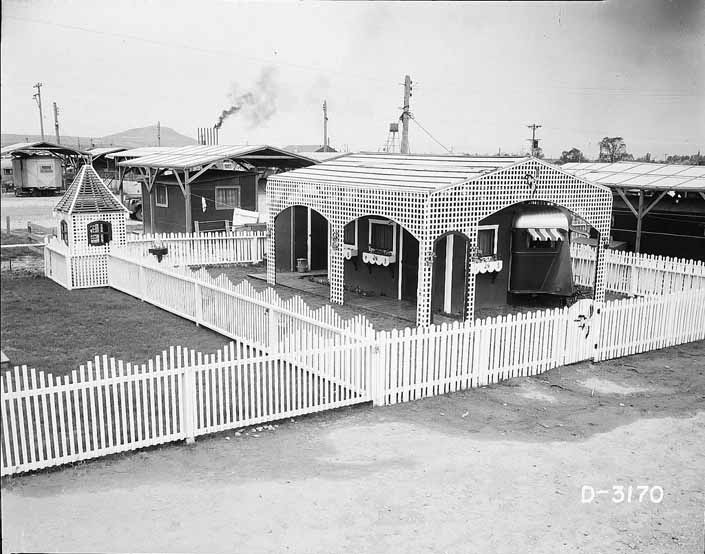 Government photo shows a 1940's worker's trailer, surrounded by a beautiful white picket fence, at Project Hanford Trailer City