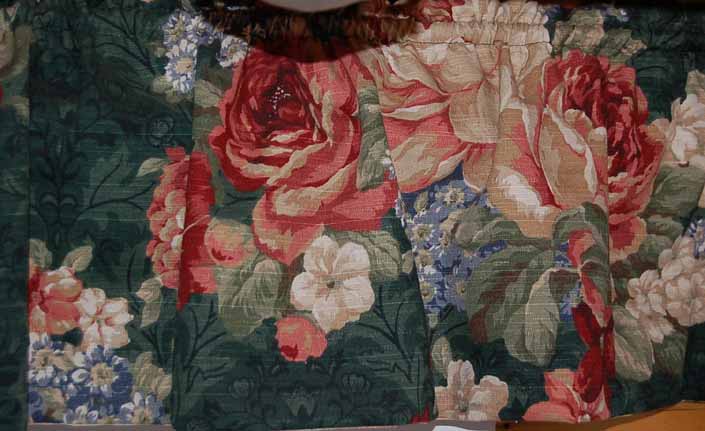 This photo shows a swatch of retro fabric with an old-fashioned muted florals design, for your vintage trailer