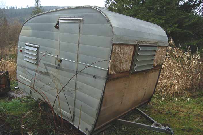 Restorable Shasta COmpact trailer parked in a vintage trailer Storage-Yard