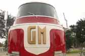 Front view of imposing 1941 GM Futurliner bus, showing bold GM block letters