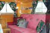 Beautiful Victorian-style upholstered couch in restored 1949 Vagabond Trailer