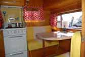 Perfect restoration of the stove and dinette area in a 1955 Aljoa vintage canned ham trailer