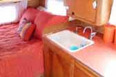 Warm and cozy bedroom area in a classic 1955 Shasta travel trailer