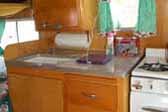 Photo of 1956 Shasta 1500 trailer showing beautiful birch cabinetry