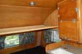 Photo shows bedroom and ceiling hammock in 1956 Shasta 1400 Travel Trailer