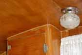Birch kitchen cabinets and stovck ceiling lamp fixture in 1956 Shasta 1400 Trailer