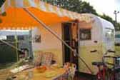 1958 Aloha canned ham trailer with matching yellow and white striped side awning