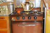 Vintage Princess gas stove with bronze finish, in 1959 Shasta Airflyte Trailer