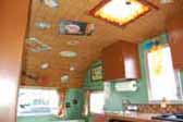 Picture of 1960 Aloha 15ft travel trailer decorated with bamboo mat ceiling and Hawaiian retro accessories