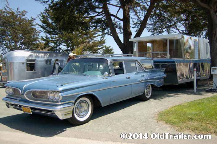 This vintage towing rig is a 1959 pontiac catalina wagon pulling a 1960 holiday house travel trailer