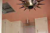 Picture showing restored pink appliances and metal retro ceiling lamp in 1961 vintage Holiday House trailer