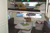 Photo shows sleeping loft over dining area in 1964 Aloha trailer cab-over model