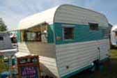 Beautifully restored vintage 1965 Aloha travel trailer with fiberglass awning window shade panel over front windows