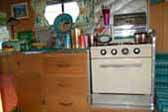 Picture shows restored oven and kitchen countertop cabinet in vintage 1965 Aloha trailer