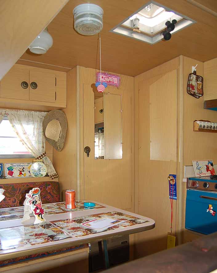 The Dining table and kitchen area in a vintage Aladdin Trailer