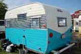 Photo of Aloha trailer with blue and white paint and polished quilted aluminum skin panel
