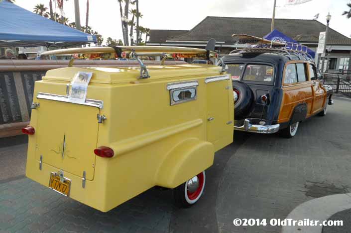 This vintage towing rig is a classic ford woodie station wagon pulling a vintage trailorboat trailer