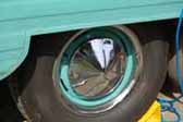 Image shows an example of a vintage trailer wheel painted light blue and with a pointy hubcap