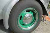 Here is a great example of a vintage teardrop trailer with after-market wheels painted green, and with a small hubcap
