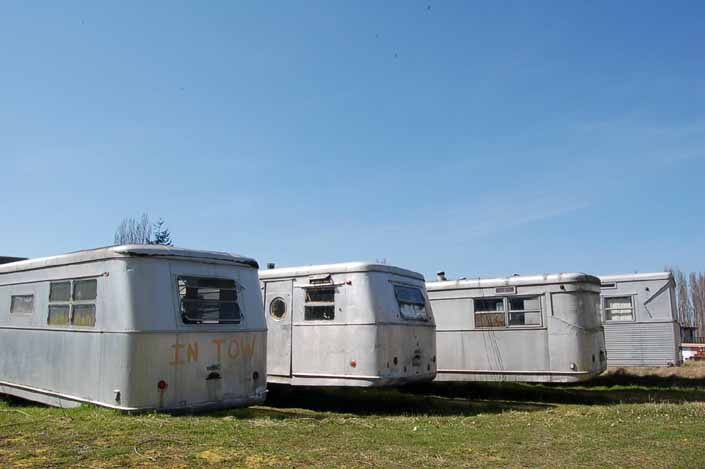 Vintage trailer Storage Yard has row of Spartan Manor vintage trailers ready for restoration