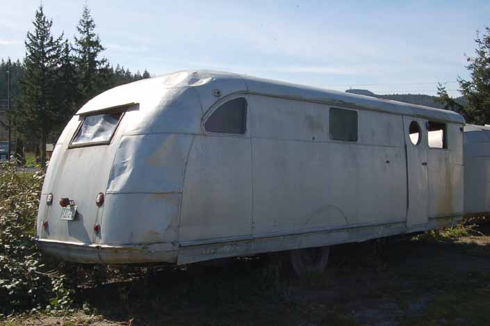 Vintage trailer junk yard has a tired but restorable Spartan with damaged aluminum skin