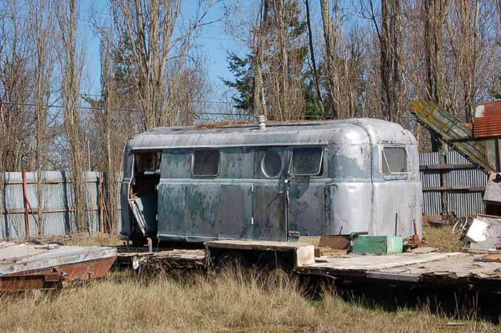 Vintage trailer junk yard has a rare Palace vintage trailer ready to be restored